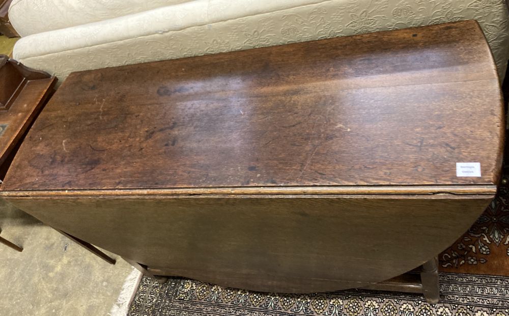 An 18th century oak oval topped gateleg dining table, fitted single drawer, width 130cm depth 50cm height 74cm